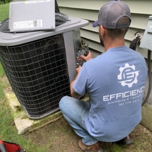 worker fixing HVAC unit